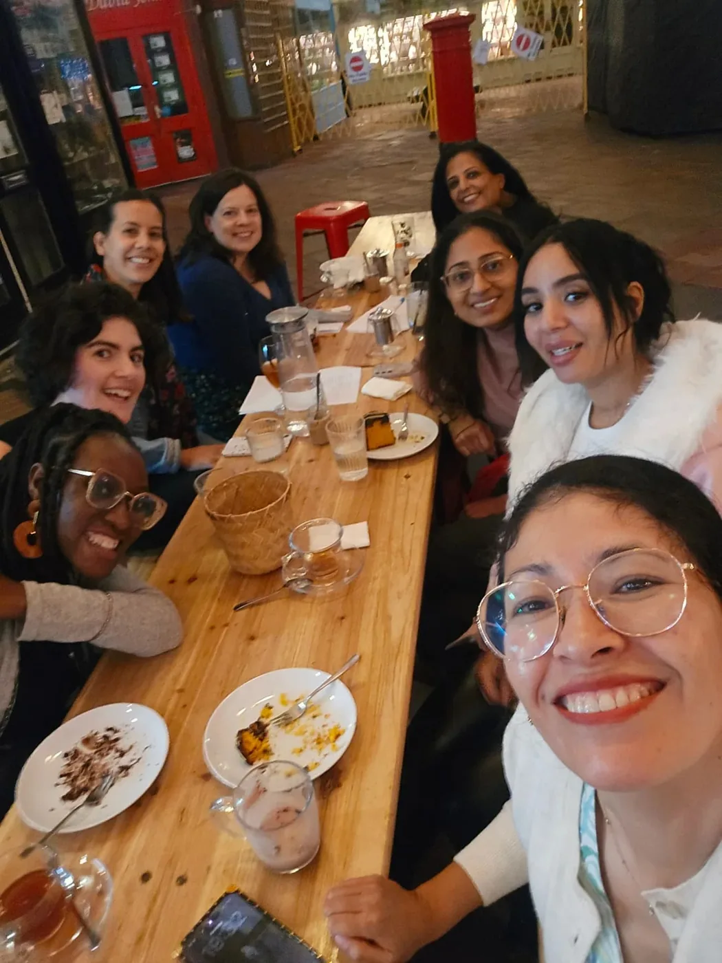A Neya group sharing a meal around one long table